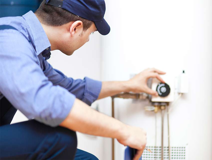master plumber from the local water-heater company inspects unit
